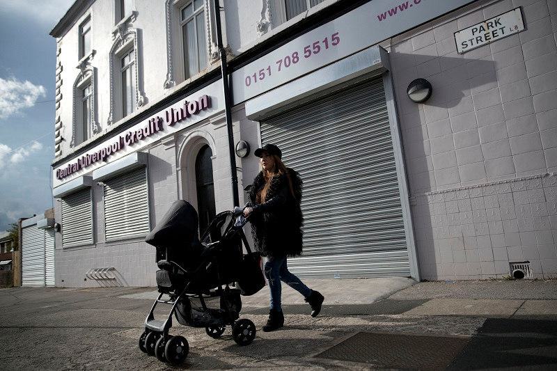 Lady with pushchair outside Central Liverpool Credit Union (Photo: Jess Hurd)