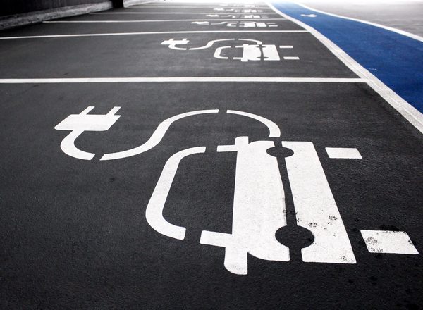 A car park with a series of electric vehicle charging point parking spaces