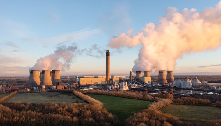 Drax coal fired power plant in North Yorkshire, UK with coal stack and Biomass storage tanks at sunset