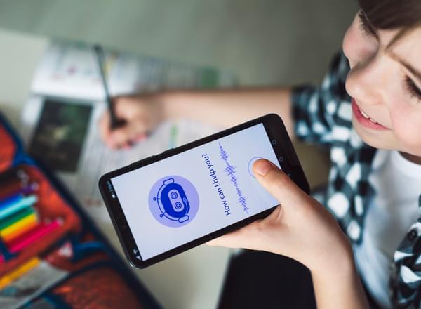 A girl doing schoolwork talking to an AI chat bot on her phone