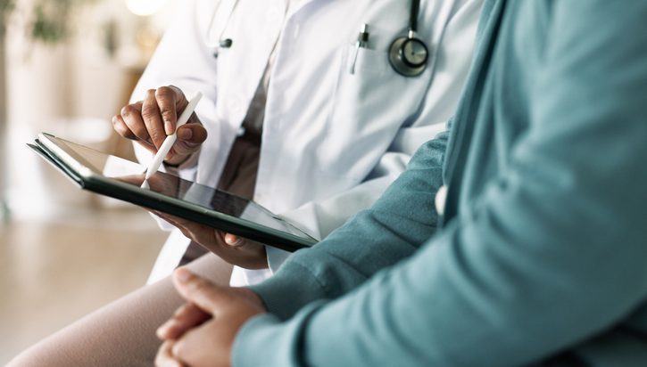 Doctor with patient for consultation, medical advice or procedure at clinic