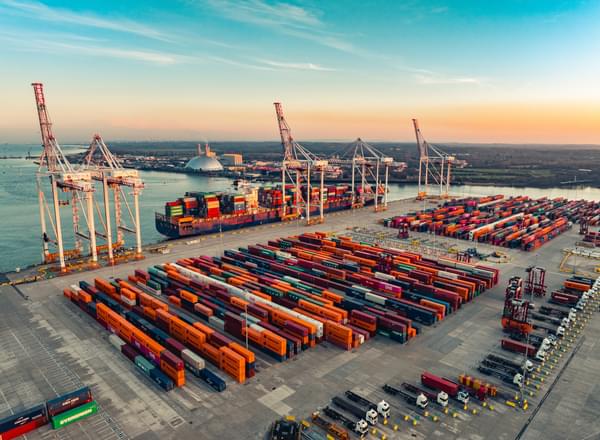 Shipping containers at Port of Southampton captured by drone at sunrise