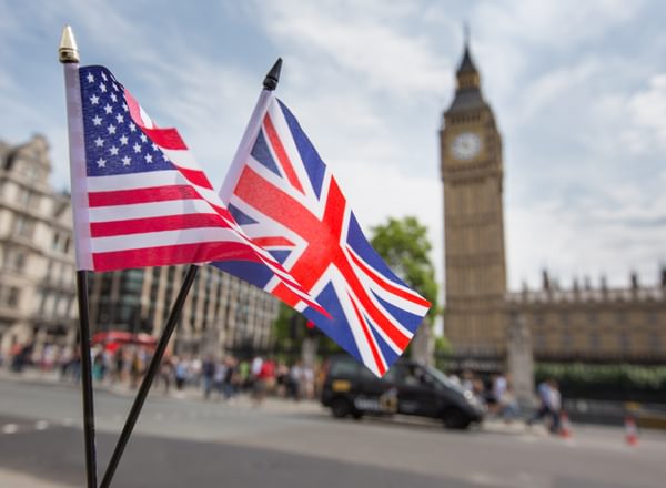 Union Jack flag and the Stars and Stripes flag of the USA, fluttering together in front of Big Ben in Westminster