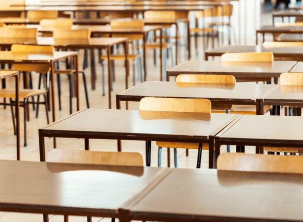 Empty rows of school desks