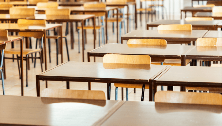 Empty rows of school desks
