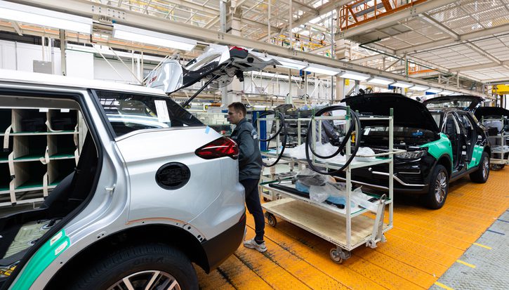 A man inspects a car on the production line