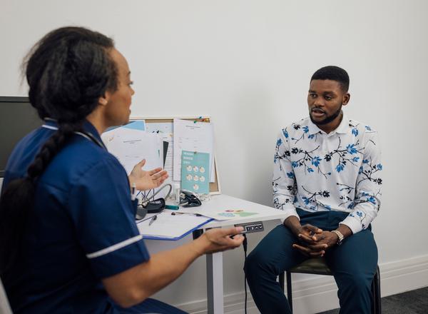 A medical professional speaking to a patient